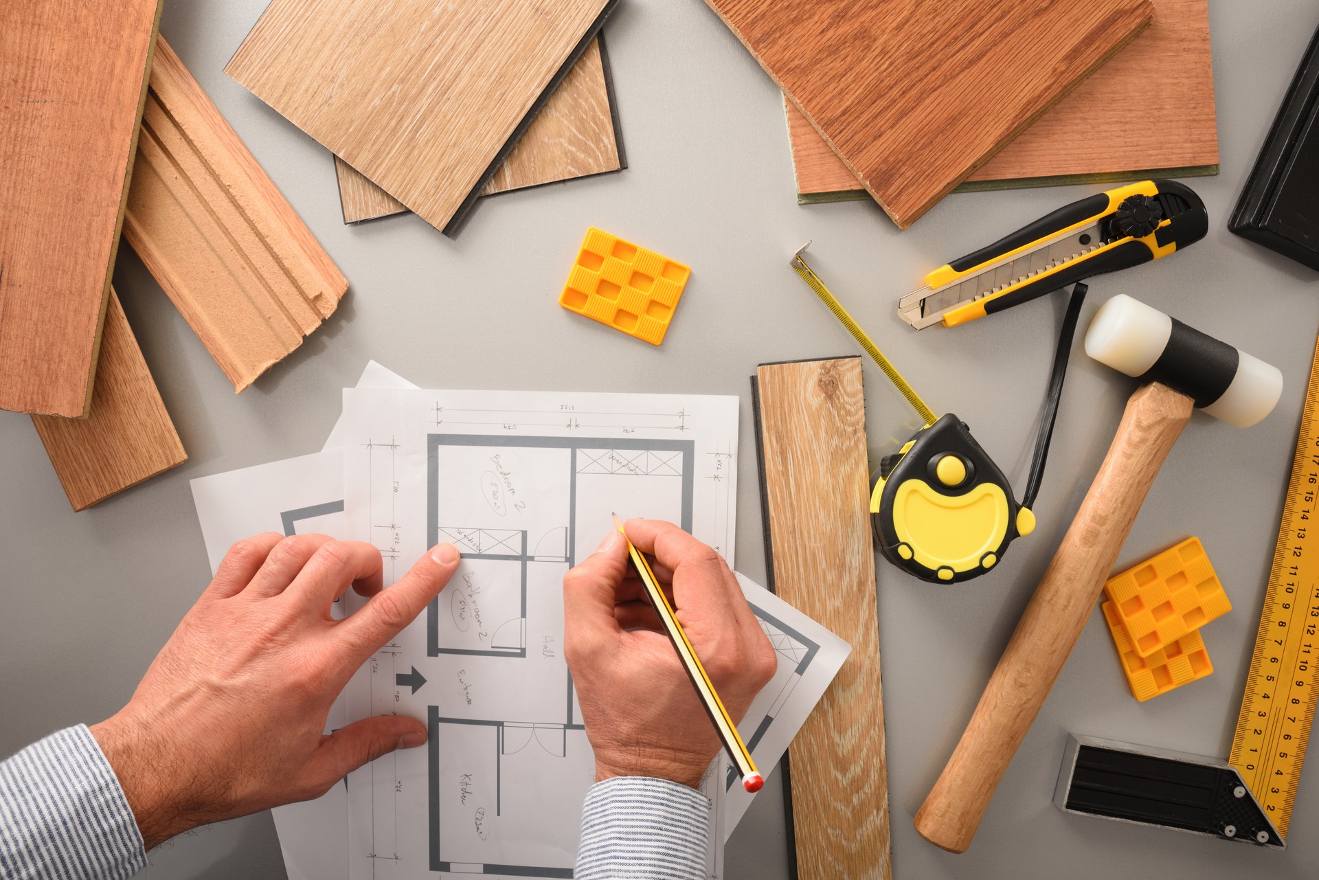 Hands in office developing interior project with wood top view